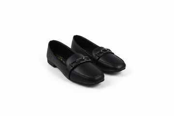 A pair of black leather loafers with a decorative metal buckle strap across the vamp, displayed on a light gray studio background.
