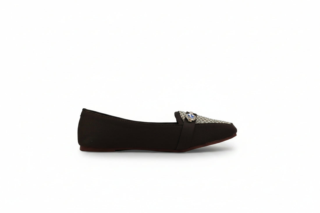 A pair of tan flat loafers with woven pattern toe caps and a small silver rhinestone buckle, displayed on a white studio background.