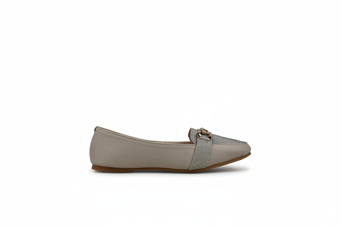 A pair of black flat loafers with a gold-tone double-ring chain detail across the vamp, displayed on a light gray fabric background.