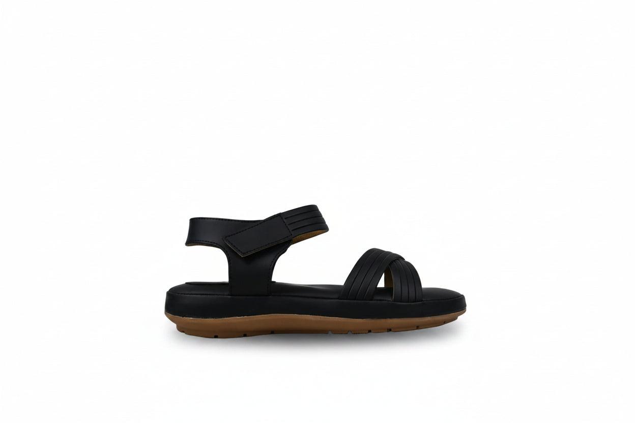 A single black rubber sandal with a brown sole, shown in profile against a light gray textured background.