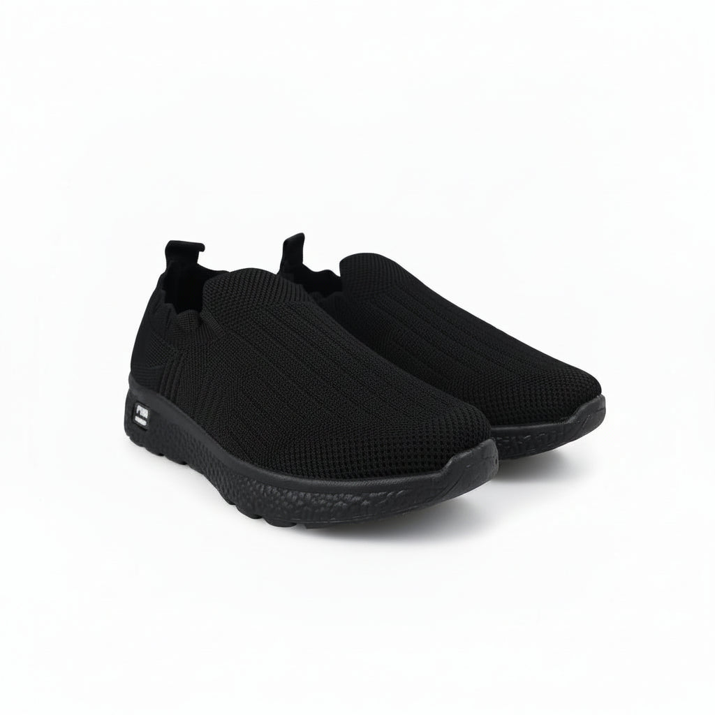 A pair of black slip-on knit sneakers with textured soles, displayed on a light gray background.