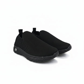 A pair of black slip-on mesh sneakers with a textured knit upper and black soles, displayed on a light gray background.
