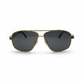 A pair of classic aviator sunglasses with a gold metal frame and dark gray lenses, displayed on a white surface with two silver studio reflectors in the background.
