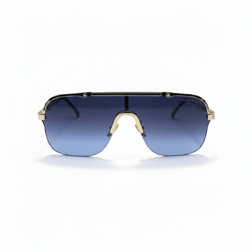 A pair of shield-style sunglasses with a gold metal frame and blue gradient lenses, displayed on a white surface with silver studio reflectors in the background.