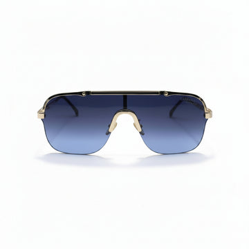 A pair of shield-style sunglasses with a gold metal frame and blue gradient lenses, displayed on a white surface with silver studio reflectors in the background.