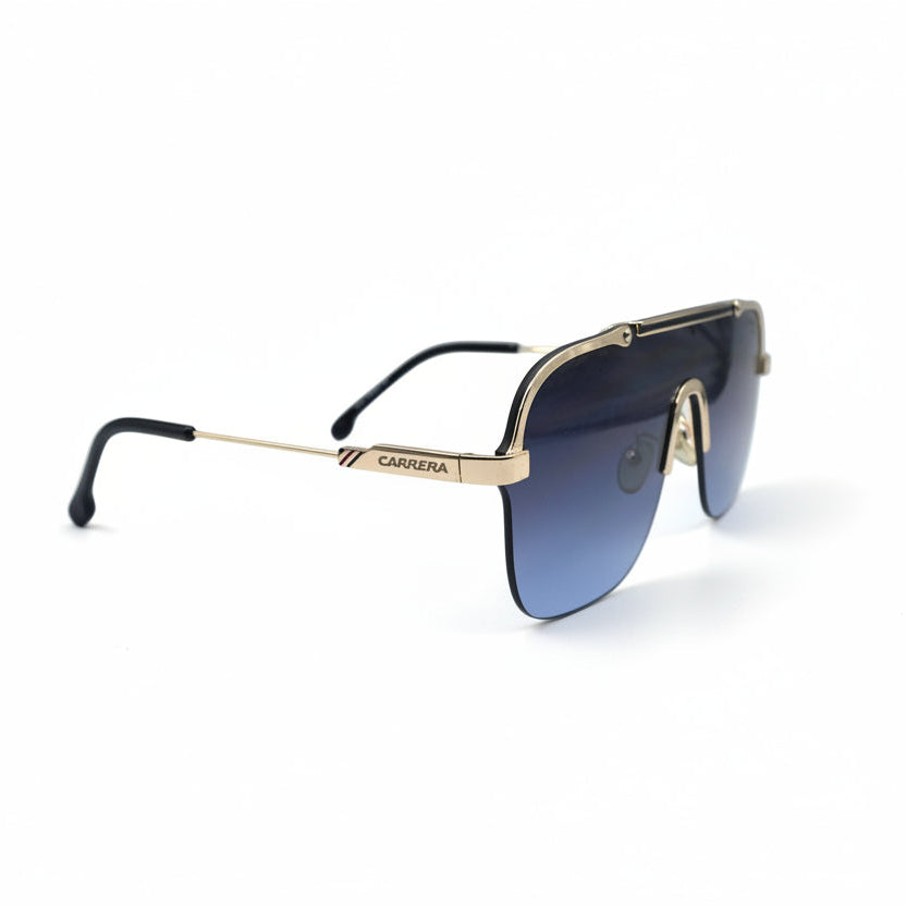 A pair of shield-style sunglasses with a gold metal frame and blue gradient lenses, displayed on a white surface with silver studio reflectors in the background.