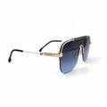 A pair of oversized aviator-style sunglasses with a gold-tone metal frame and dark blue gradient lenses, displayed on a white surface with a soft shadow.