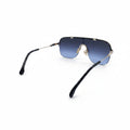 Rimless shield-style sunglasses with a gold metal frame and blue gradient lenses, displayed on a white surface with a silver textured case partially visible on both sides.