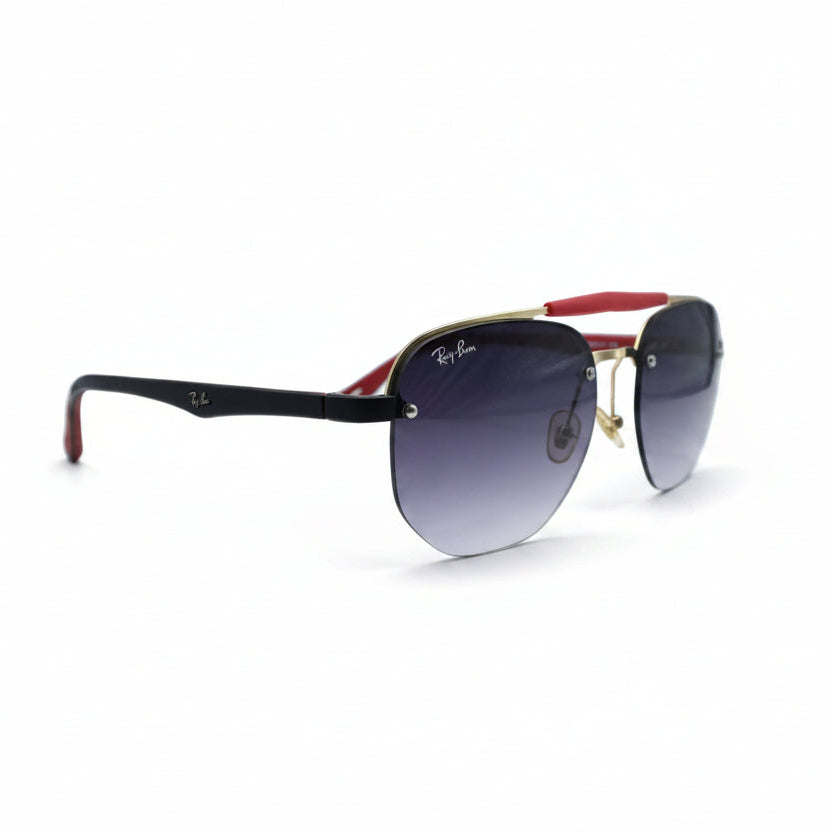 Ray-Ban Aviator sunglasses with a black acetate frame, gold metal rims, gradient purple lenses, and red temple tips, displayed on a white surface between two gray softbox lights.