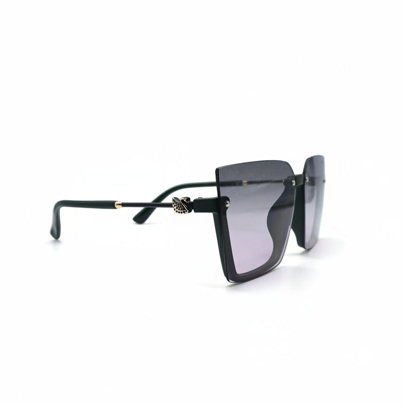 A pair of square-frame sunglasses with a black acetate frame and gradient pink-tinted lenses, displayed on a white surface between two silver studio reflectors.