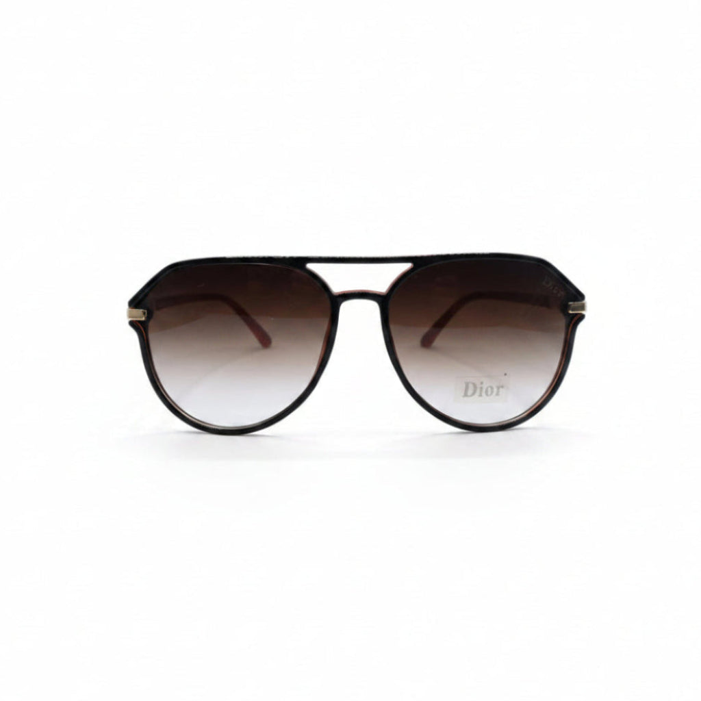 Dior aviator sunglasses with dark brown gradient lenses and gold metal frames, displayed on a white surface between two silver textured panels.