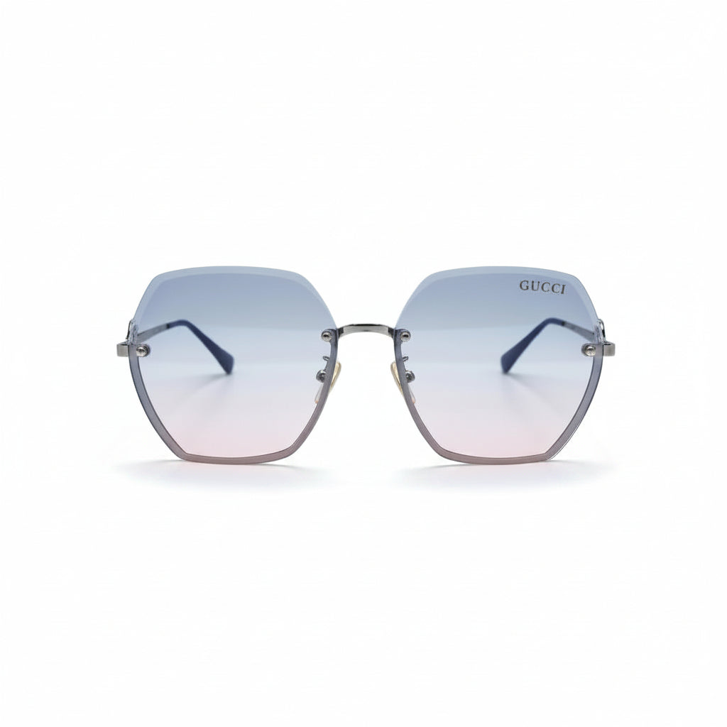 Gucci oversized square rimless sunglasses with a silver-tone metal frame and gradient lenses that fade from light blue at the top to soft pink at the bottom. The Gucci logo is visible on the upper right lens, and a small gold logo charm hangs from the bottom corner.