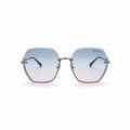 Gucci oversized square rimless sunglasses with a silver-tone metal frame and gradient lenses that fade from light blue at the top to soft pink at the bottom. The Gucci logo is visible on the upper right lens, and a small gold logo charm hangs from the bottom corner.