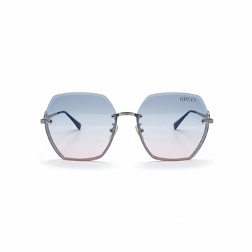 Gucci oversized square rimless sunglasses with a silver-tone metal frame and gradient lenses that fade from light blue at the top to soft pink at the bottom. The Gucci logo is visible on the upper right lens, and a small gold logo charm hangs from the bottom corner.