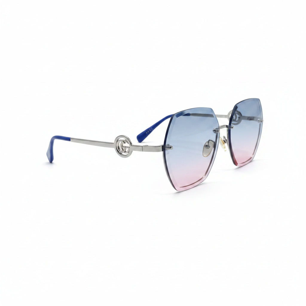 Gucci oversized square rimless sunglasses with a silver-tone metal frame and gradient lenses that fade from light blue at the top to soft pink at the bottom. The Gucci logo is visible on the upper right lens, and a small gold logo charm hangs from the bottom corner.