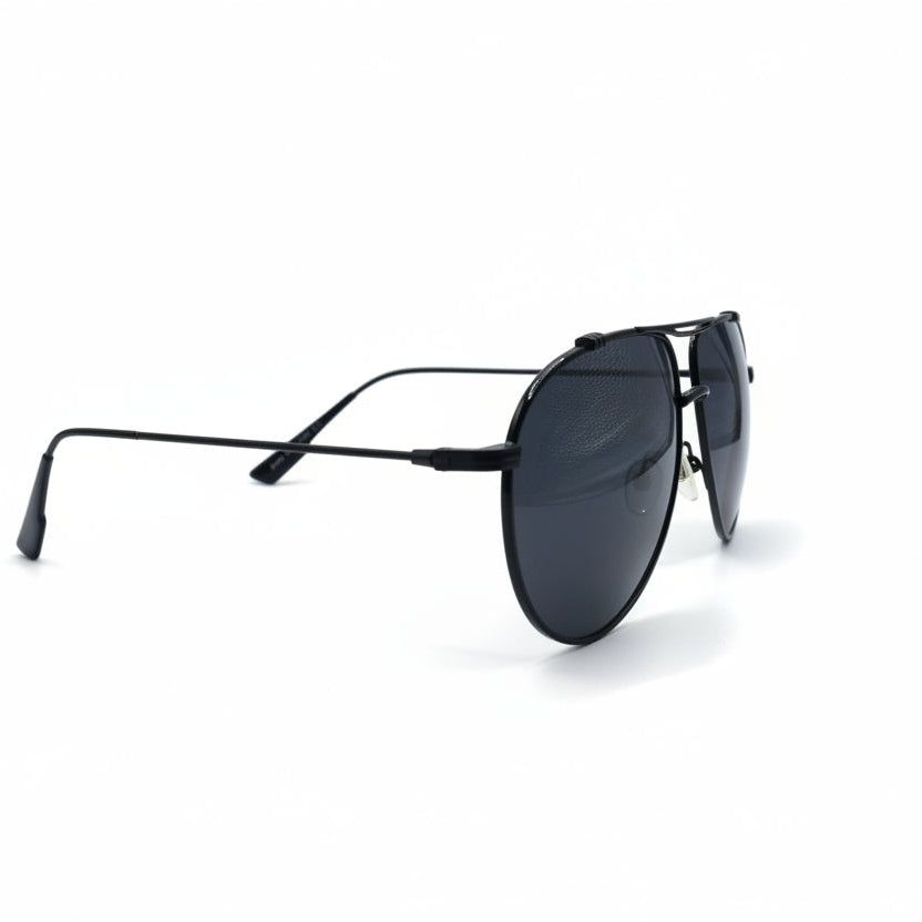 A pair of classic aviator sunglasses with a thin black metal frame and dark gray lenses, displayed on a white surface with two silver studio reflectors in the background.