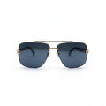 A pair of aviator-style sunglasses with a gold metal frame and dark gray lenses, displayed on a white surface between two textured silver panels.