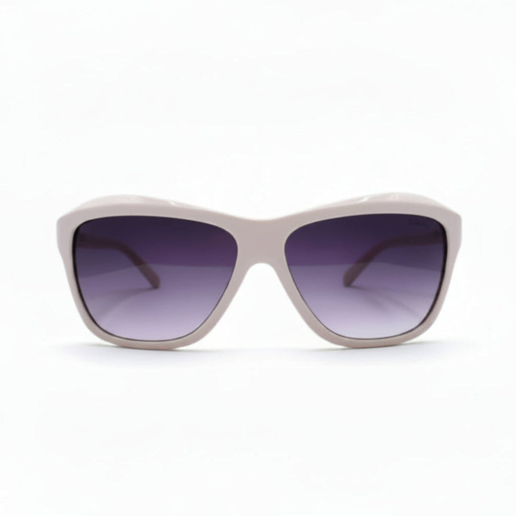 A pair of oversized square sunglasses with a light pink frame and dark purple gradient lenses, displayed on a white surface with soft studio lighting.