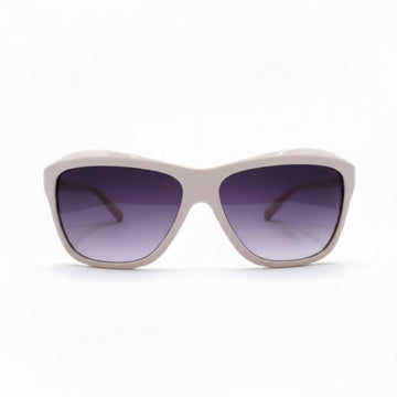 A pair of oversized square sunglasses with a light pink frame and dark purple gradient lenses, displayed on a white surface with soft studio lighting.
