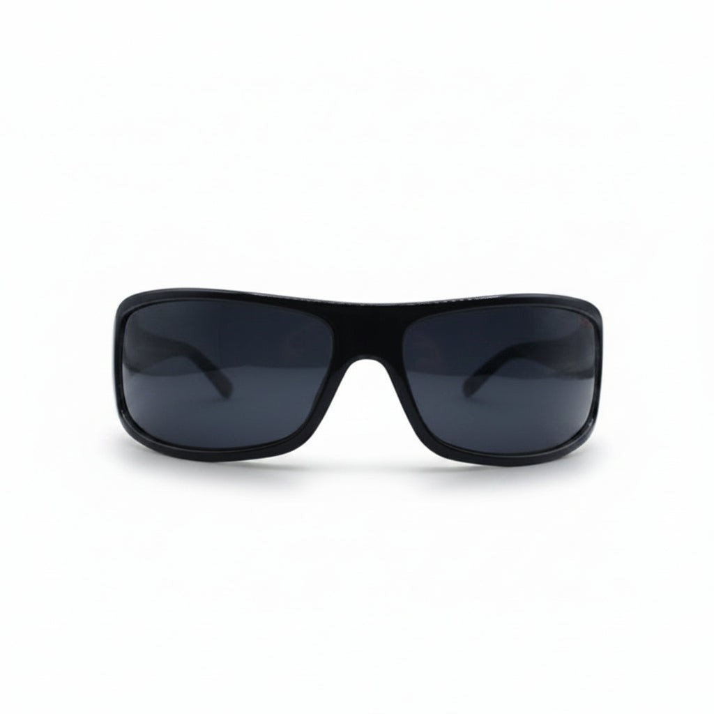 Black wrap-around sunglasses with dark lenses, displayed on a white surface with two textured silver panels in the background.