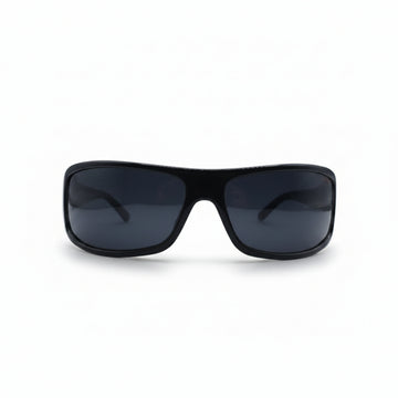 Black wrap-around sunglasses with dark lenses, displayed on a white surface with two textured silver panels in the background.