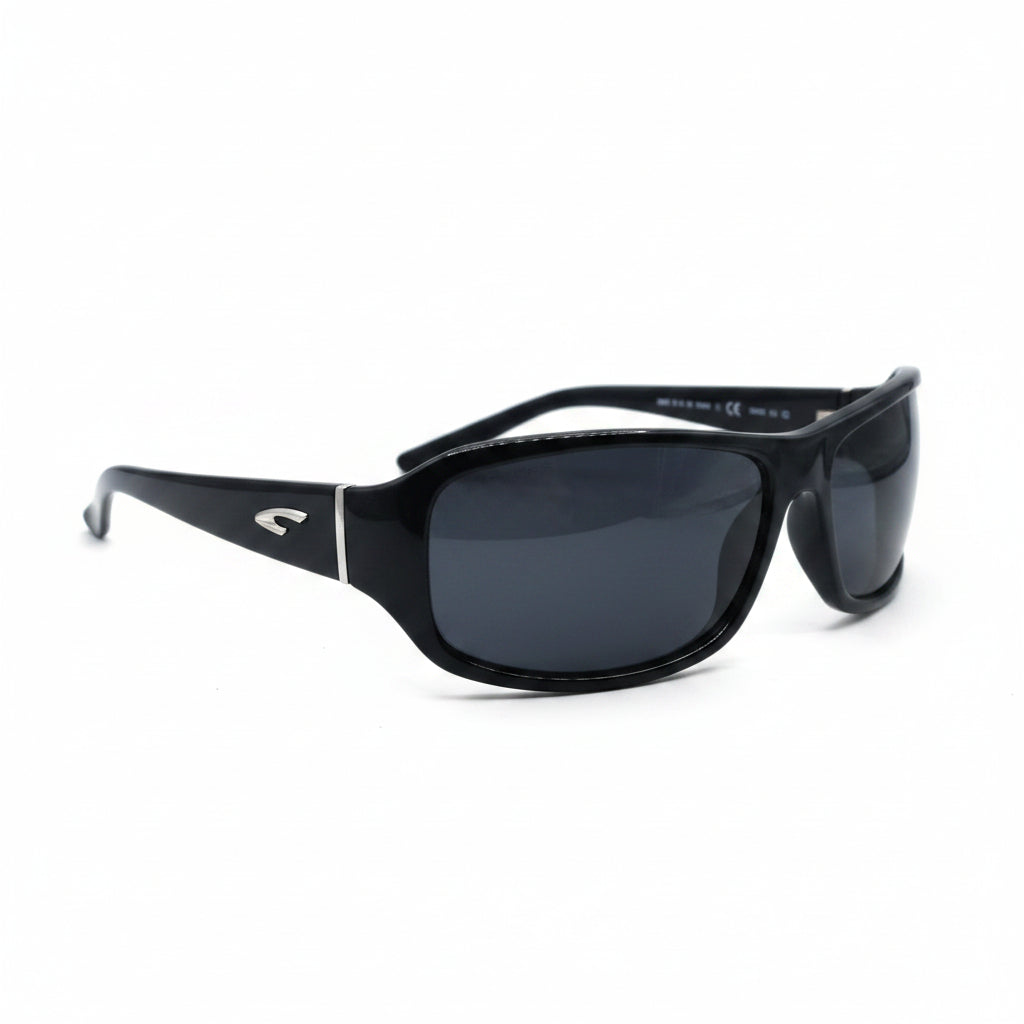 Black wrap-around sunglasses with dark lenses, displayed on a white surface with two textured silver panels in the background.