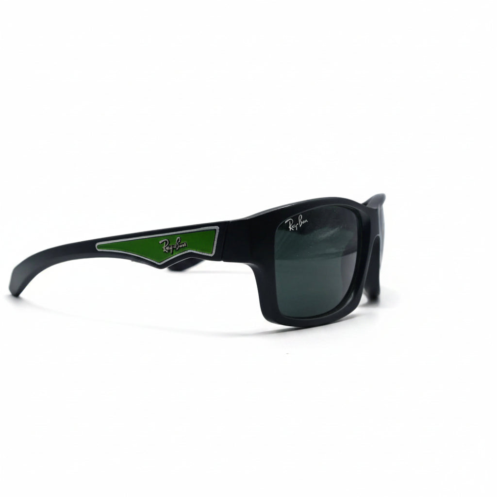 Black Ray-Ban sunglasses with a green accent on the temple arm, displayed on a white surface between two silver reflective stands.