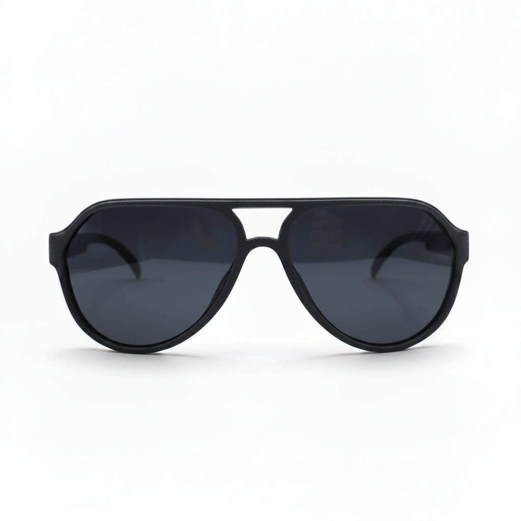 Black aviator-style sunglasses with dark lenses, displayed on a white surface with a reflective silver backdrop visible on both sides.