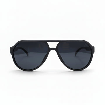 Black aviator-style sunglasses with dark lenses, displayed on a white surface with a reflective silver backdrop visible on both sides.