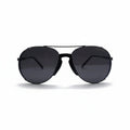 A pair of black aviator sunglasses with dark lenses, displayed on a white surface with a reflective silver backdrop.
