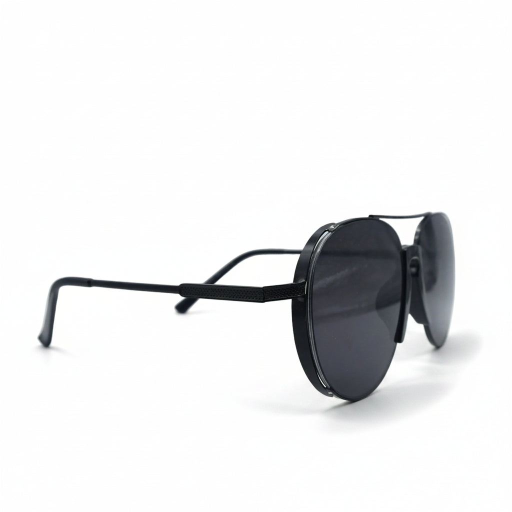 A pair of black aviator sunglasses with dark lenses, displayed on a white surface with a reflective silver backdrop.