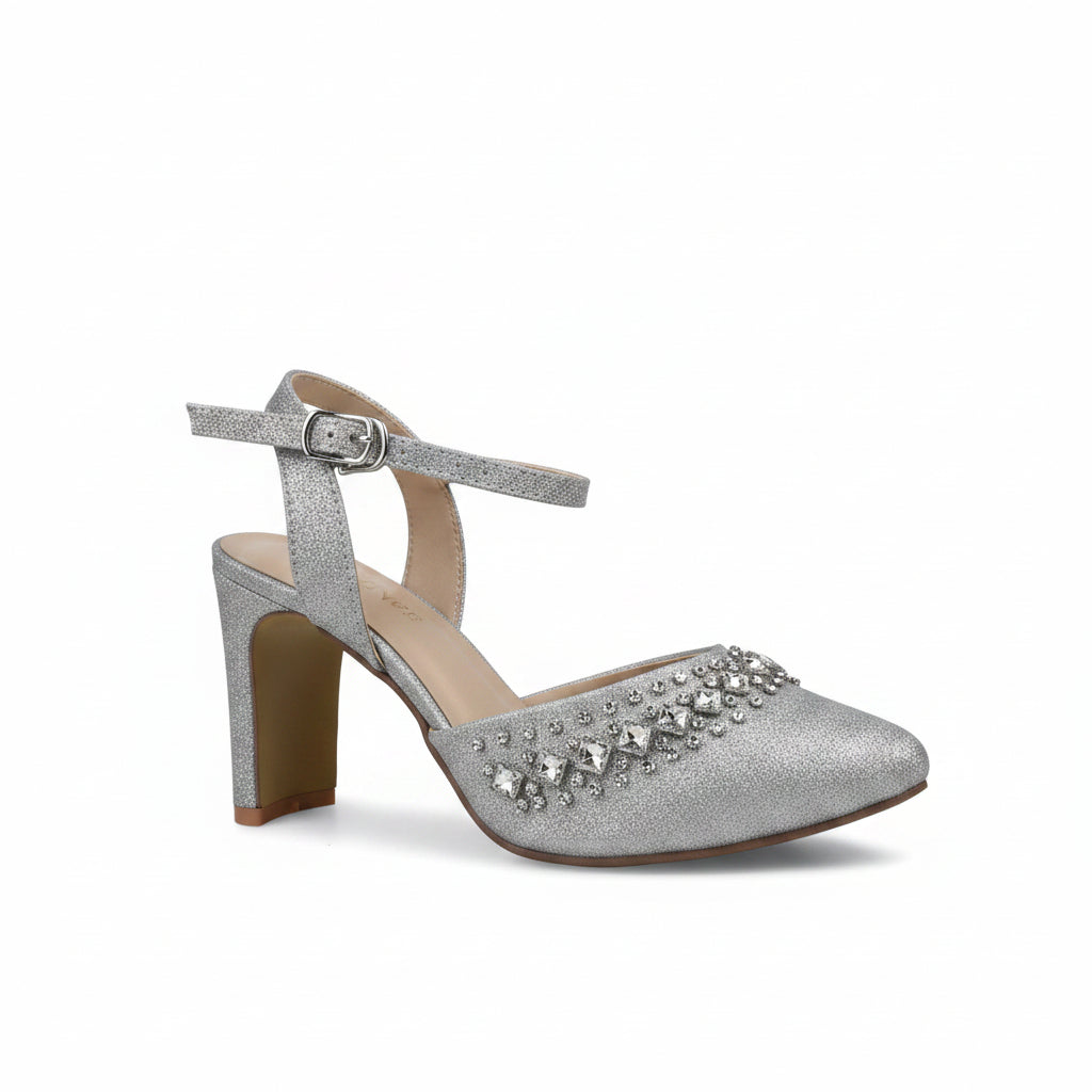 A single silver glitter high-heeled sandal with an ankle strap, pointed toe, and a decorative cluster of clear rhinestones on the vamp, shown against a light gray background.