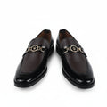 A pair of dark brown leather loafers with a shiny finish and a gold-tone metal horsebit detail across the top, displayed against a white background.
