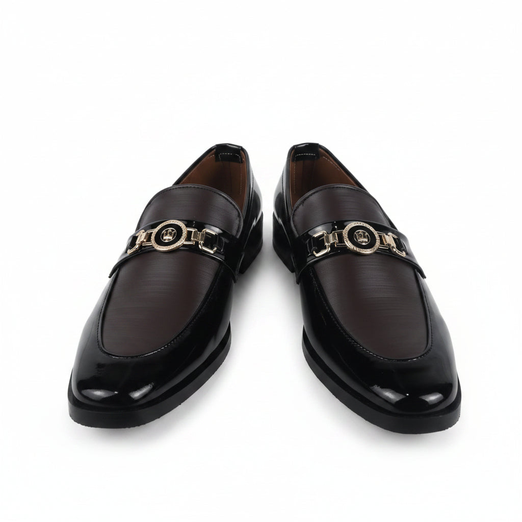 A pair of dark brown leather loafers with a shiny finish and a gold-tone metal horsebit detail across the top, displayed against a white background.