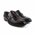 A pair of dark brown leather slip-on loafers with a single strap and a silver-tone buckle, displayed on a light gray background.