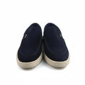 A pair of navy blue slip-on shoes with cream-colored soles, photographed against a plain white background.
