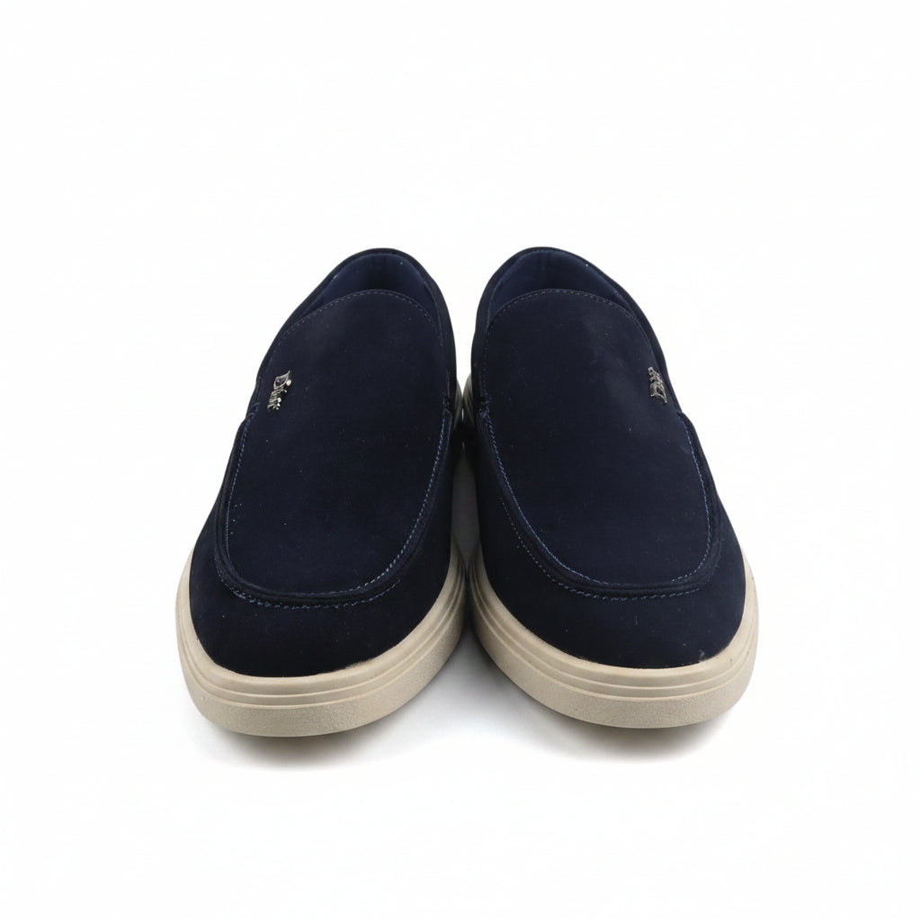 A pair of navy blue slip-on shoes with cream-colored soles, photographed against a plain white background.