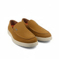 A pair of tan suede slip-on loafers with cream-colored soles, displayed on a white studio background.
