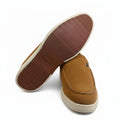 A pair of tan suede slip-on shoes, with one shoe standing upright to show the side and the other lying on its side to display the brown textured outsole.