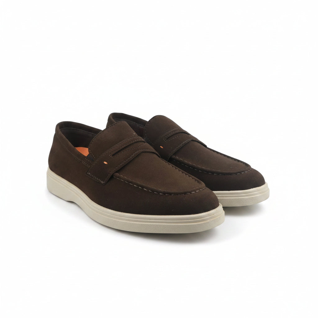 A pair of dark brown suede penny loafers with cream-colored soles, displayed on a white studio background.