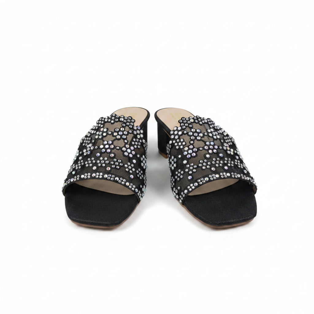 A pair of women's black mule sandals with chunky block heels and wide straps heavily embellished with silver rhinestones, shown on a white studio background.