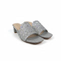 A pair of women's heeled mule sandals in glittery silver with extensive crystal embellishments, displayed on a white studio background.