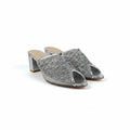 A pair of women's open-toe mule heels with chunky block heels, featuring a textured silver glitter upper and a light beige insole, photographed on a white studio background.