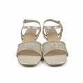 A pair of women's metallic gold heeled sandals with square toes and thin ankle straps, shown against a plain light gray background.