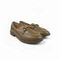 A pair of tan faux-croc woven loafers with gold-tone buckle details, photographed on a white studio background.
