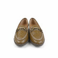 A pair of tan woven leather loafers with gold-tone horsebit details across the top, displayed on a white surface.