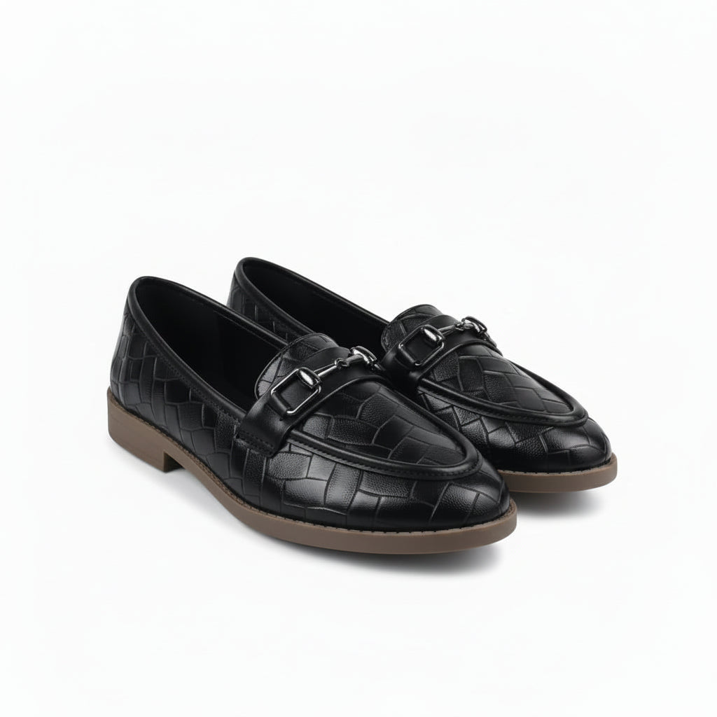 A pair of black croc-embossed leather loafers with silver buckle details and tan soles, displayed on a white studio background.