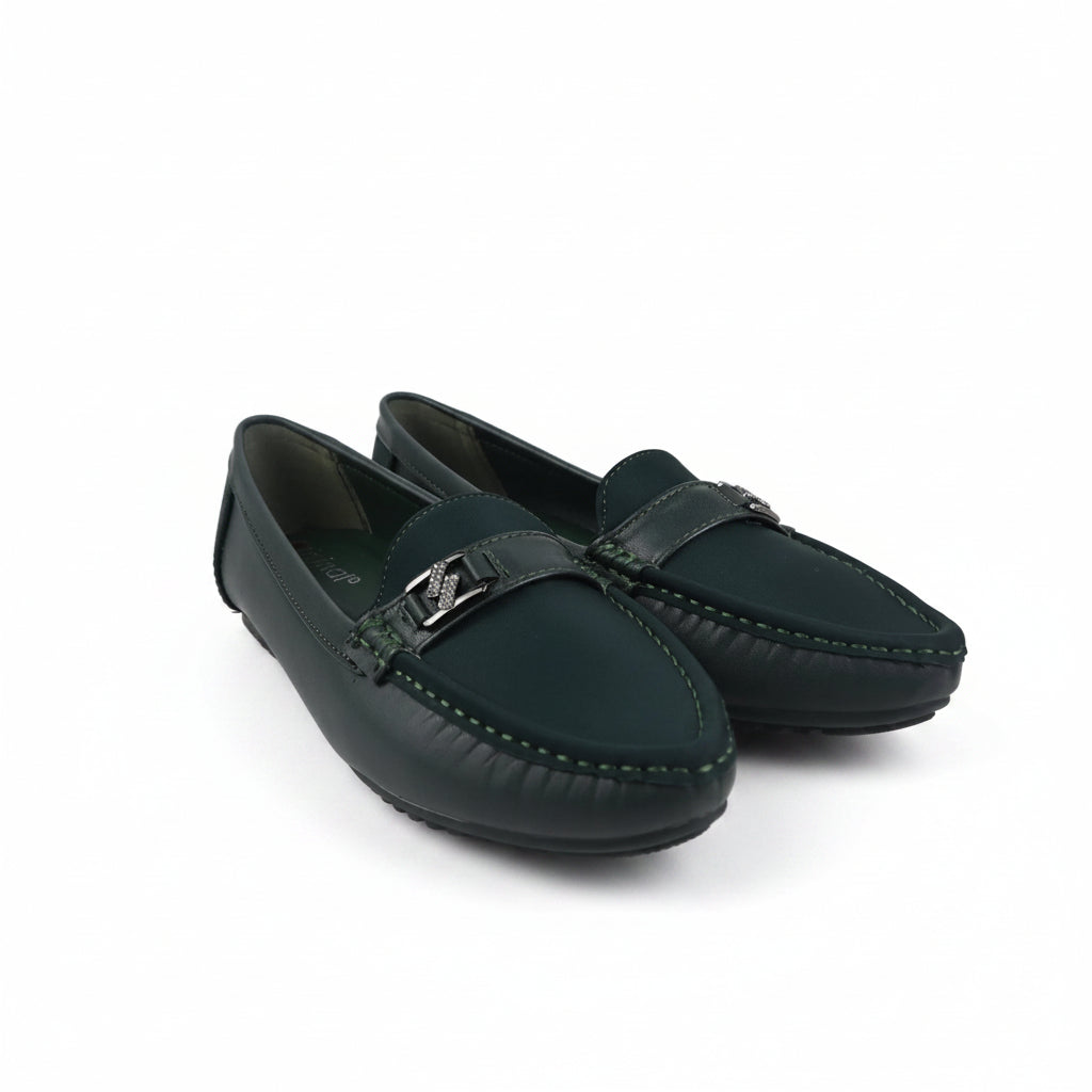A pair of dark green leather moccasin-style loafers with a silver-tone metal logo buckle on the strap, displayed on a white studio background.