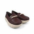 A pair of women's slip-on loafers in dark burgundy brown leather, featuring a decorative gold-tone rhinestone-embellished strap and chunky off-white platform soles, shown on a white studio background.