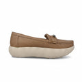 A single tan slip-on loafer-style shoe with a thick cream-colored sole, photographed from the side against a light gray backdrop.